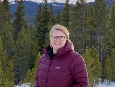 Nicole Alt with trees and mountains in the background