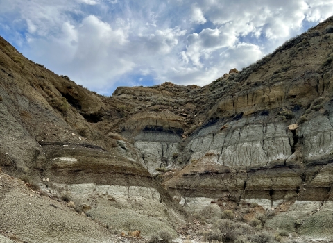 A badland formation under a cloudy sky