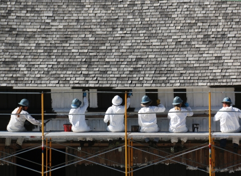In this photo: HistoriCorps volunteers work to repaint the siding to match the original color.