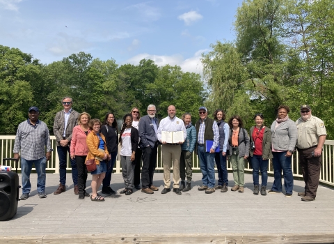 a group of community partners stand together with newly signed Urban Bird Treaty for the City of Hartford
