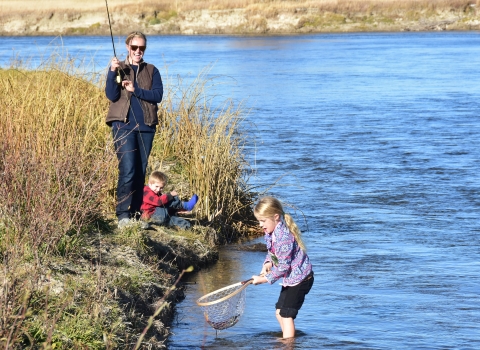 Mom and two kids having family fun day on Seedskadee National Wildlife Refuge. Mom gets an assist on the net.