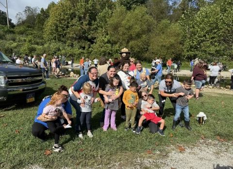 Group of kids smiling in front of stream