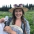  A woman with a wide brimmed hat on holding a net in an alpine meadow