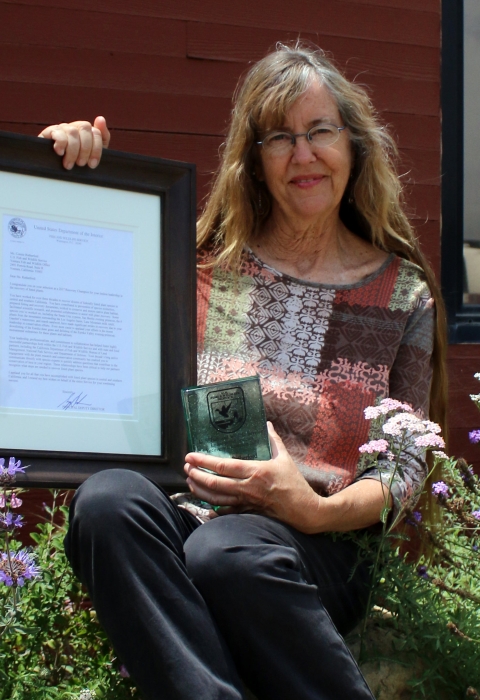A woman holding an award