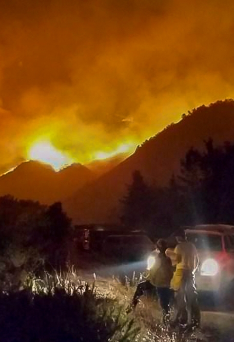 A fire sweeps across a mountainside