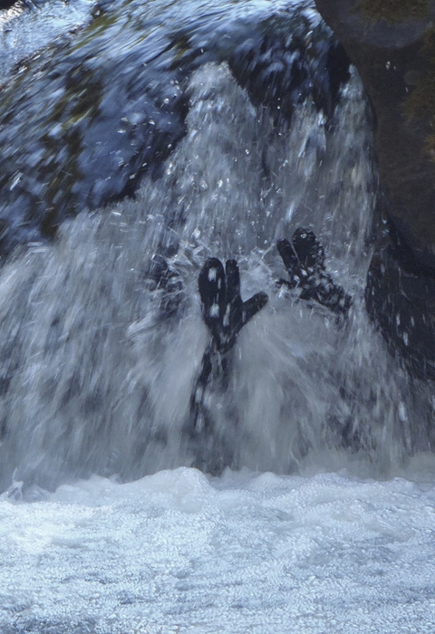 a person under a waterfall