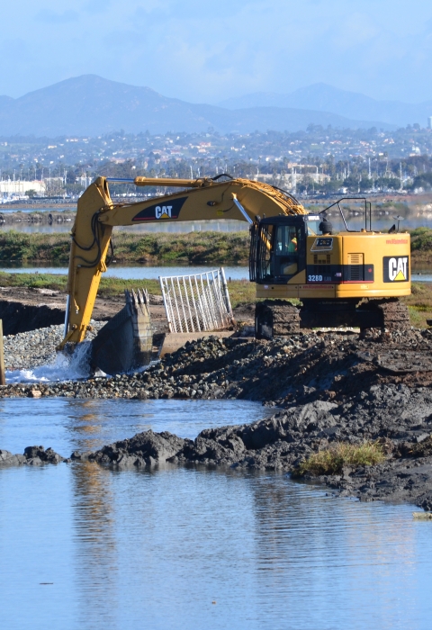 Backhoe in dredge opening