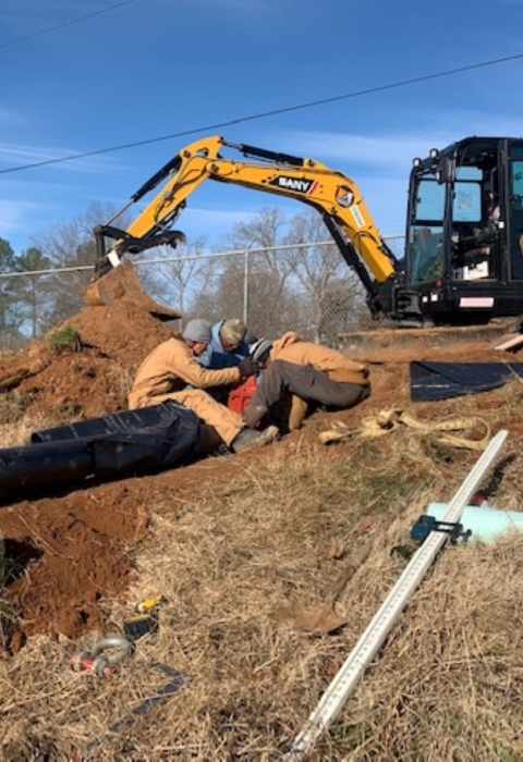 Contractors working on a valve for a pipeline project.
