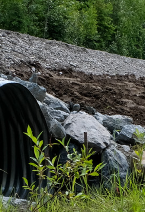 A new, wide culvert under a road improves fish passage in O'Brien Creek in Wasila, AK.