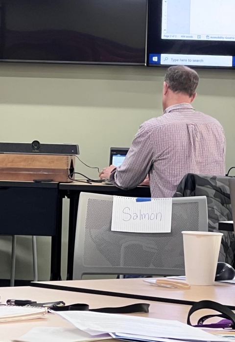 a salmon sign on a chair in an office setting