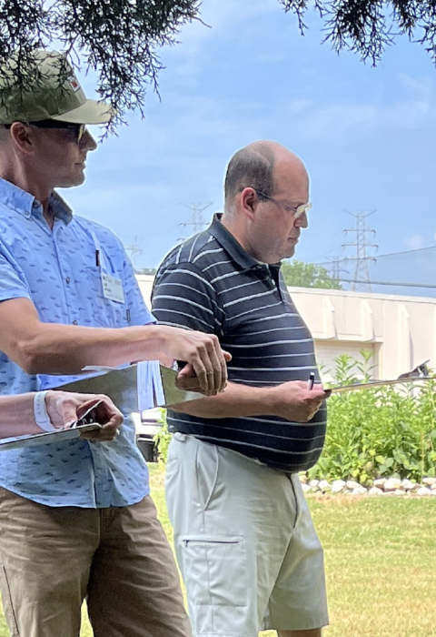 Workshop participants standing in a semi-circle outdoors