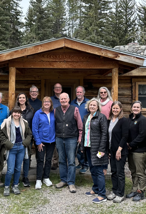 Image of group standing in front of cabin