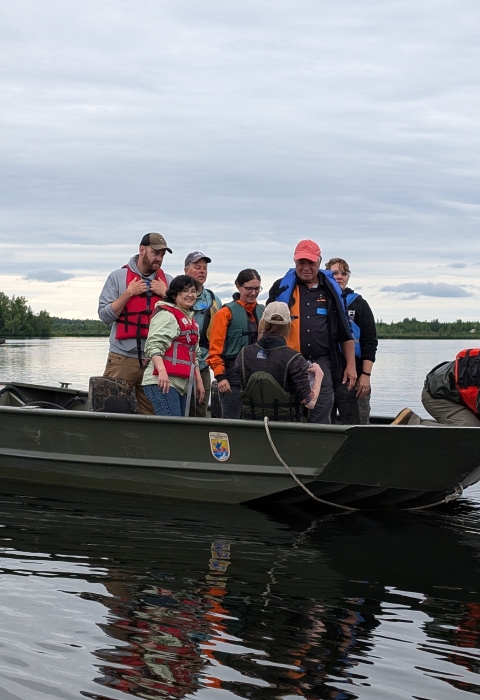 Biologist on boat sample for aquatic invasive species.