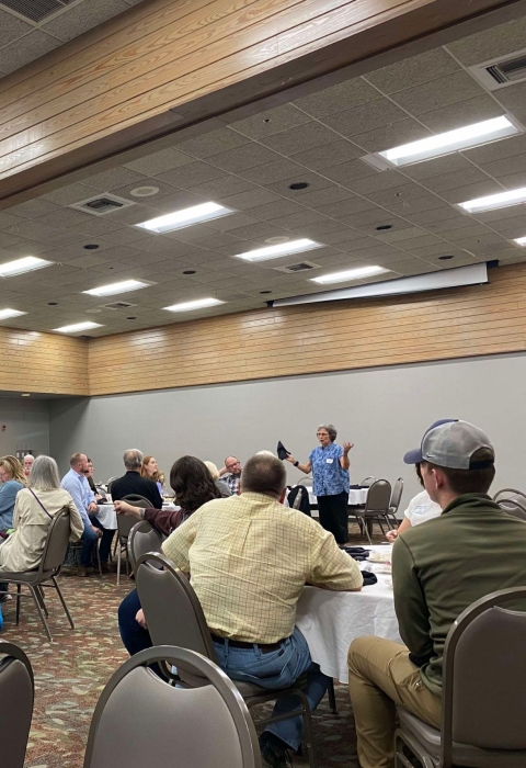People sitting at tables in conference area