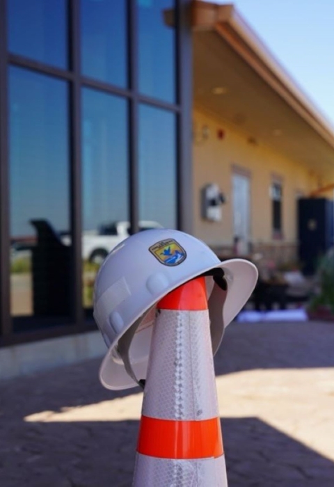 Foreground: USFWS Branded Helmet atop Hazard Cone. Background: Visitor Center of Rocky Mountain Arsenal National Wildlife Refuge