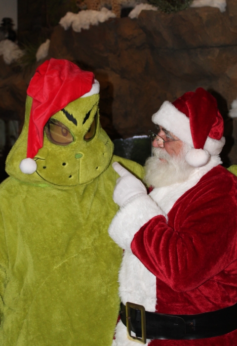 Santa pointing at the Grinch