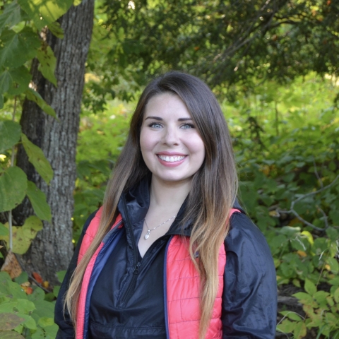 biologist in front of tree and greenery