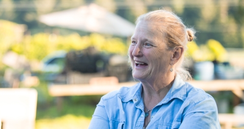 Pictured is a woman speaking enthusiastically about the farmstand 