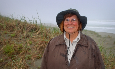 a woman posing for a photo on the beach