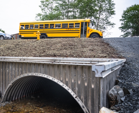 school bus passing over a fish passage culvert