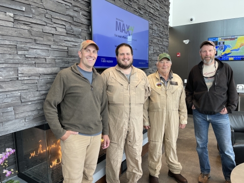 four people standing together