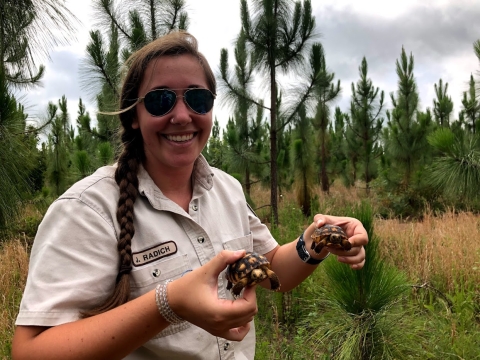 Jessica holding two gopher tortoises
