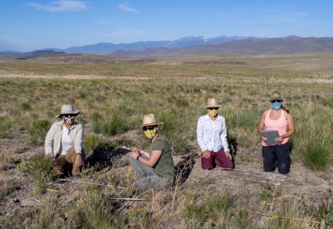 four women in sagebrush landscape with masks on to protect themselves from COVID19.