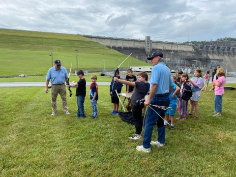 Kids and USFWS volunteers using shooting archery
