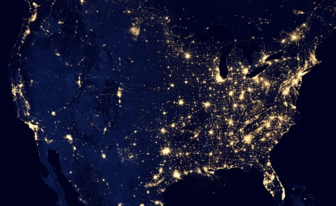 Map of the United States showing the country lit up by artificial light at night.