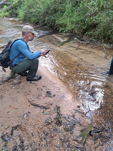 US Forest Service staff marks waypoint for future a mussel bed location