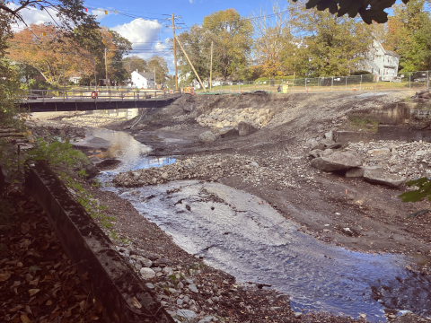 The site where High Street Dam previously was, showing low flow and a repaired bridge in the background.