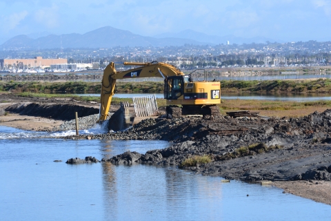Backhoe in dredge opening