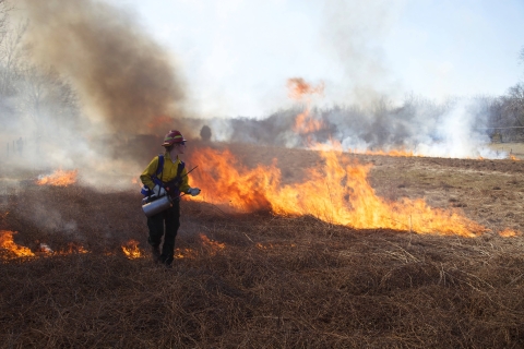 Female Firefighter holding a drop torch