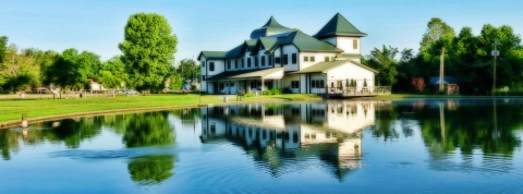 Visitor Center building reflecting on a rippled pond