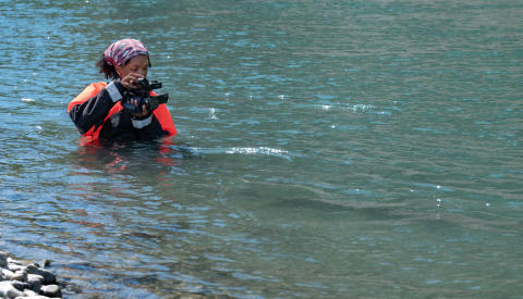 USFWS intern, Typhanie Shepherd, filming on the Elwha River in her drysuit.