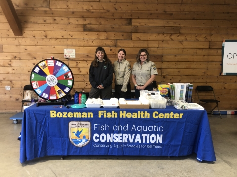Biologists attend a table with education materials