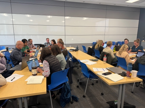 groups of people huddled around table in discussion