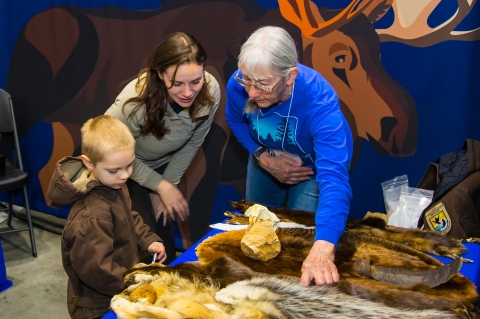 FWS Staff and Friends conduct an education activity with an event participant