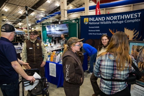 FWS Staff working doing community engagement at an outreach booth