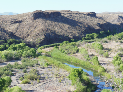 A river flowing beside mountains