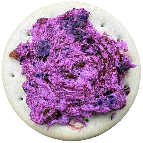 a purple spread on a cracker