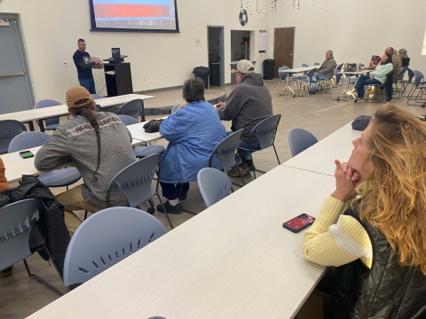 People listening to presenter in classroom