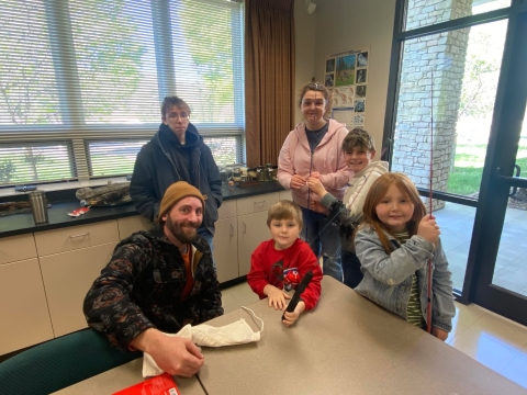 Family smiling with fishing gear