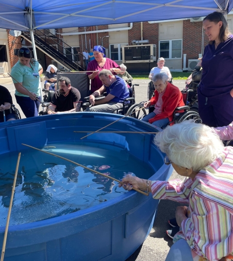 Elderly people fishing out of stock tank