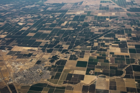 Aerial view of a city and farm fields in California