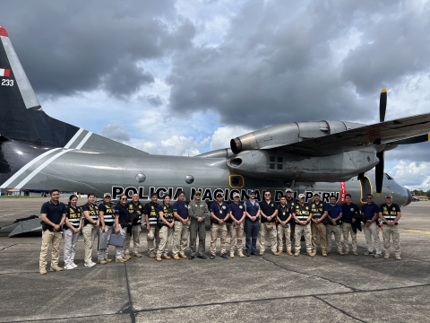 people pose beside plane
