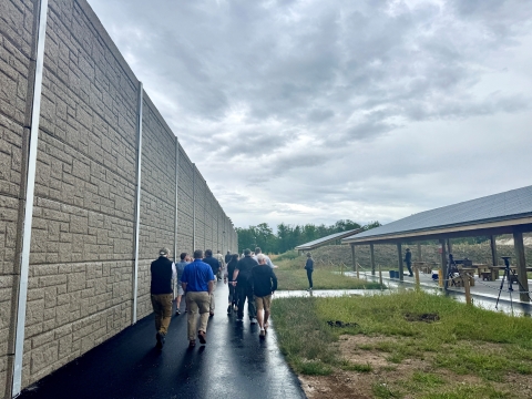 Group tour walks past new shooting benches at the Fryeburg Shooting Facility 
