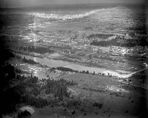 Black and white aerial photo of wetlands and warehouses