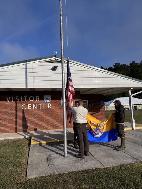 2 people raising flags