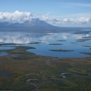 aerial photo of an undeveloped watery landscape with mountains in background
